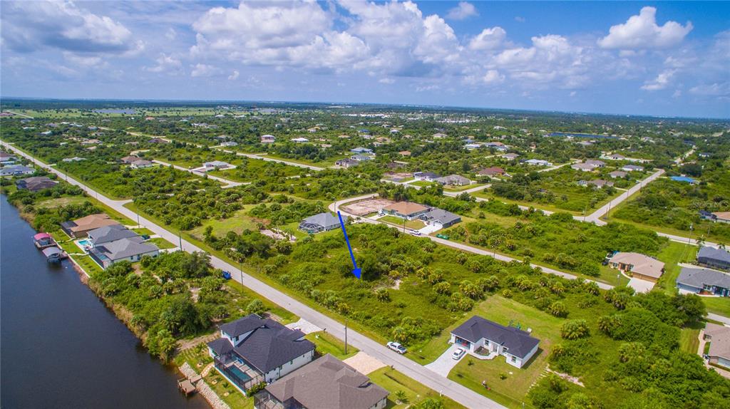 an aerial view of residential houses with outdoor space and trees