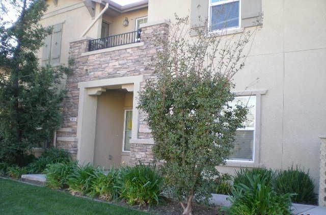 a view of a house with a yard and plants