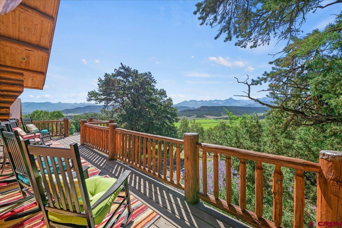 a view of a two chairs in the balcony