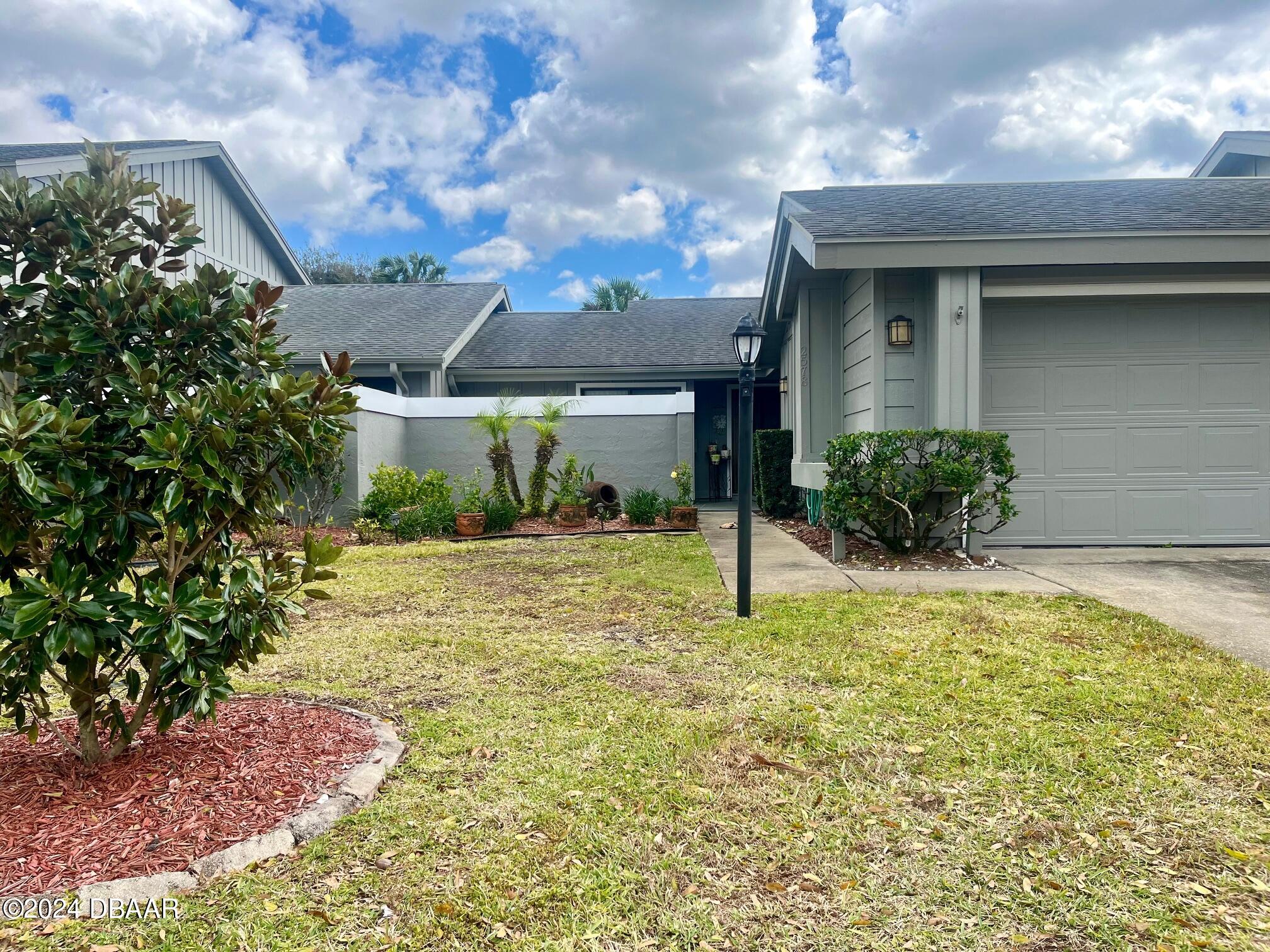 a view of a house with a yard