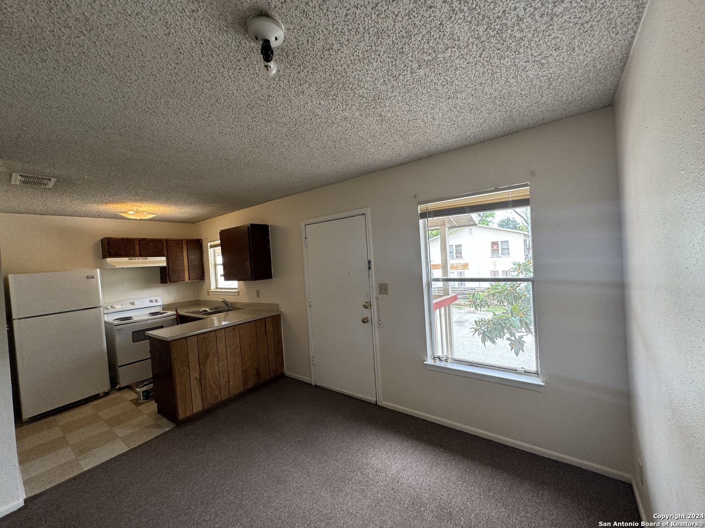 a kitchen with stainless steel appliances granite countertop a stove and a refrigerator