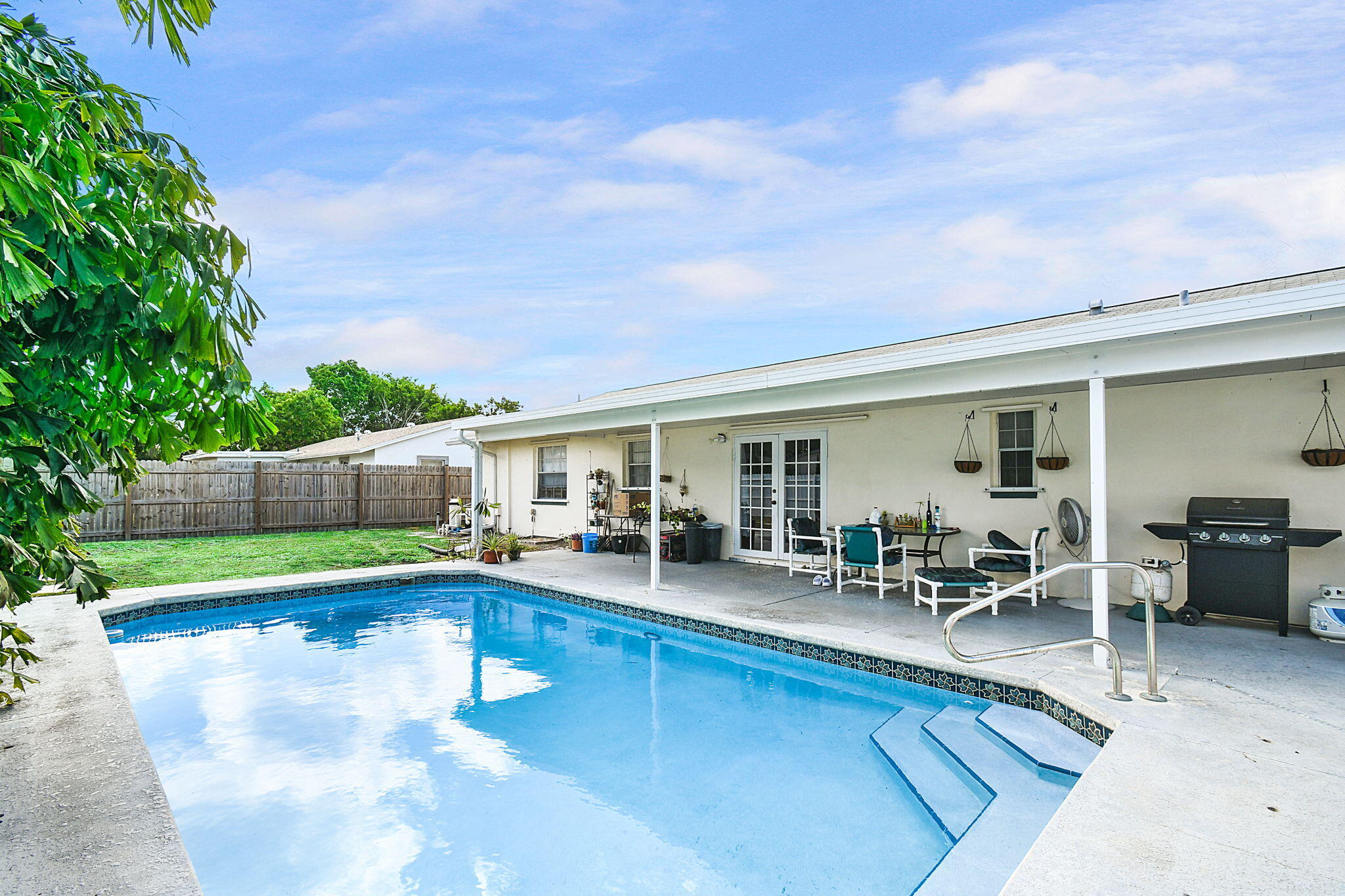 a swimming pool with outdoor seating and yard