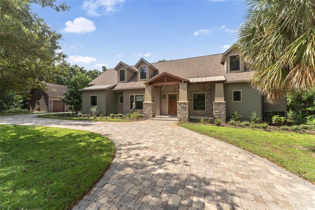 a front view of house with yard and green space