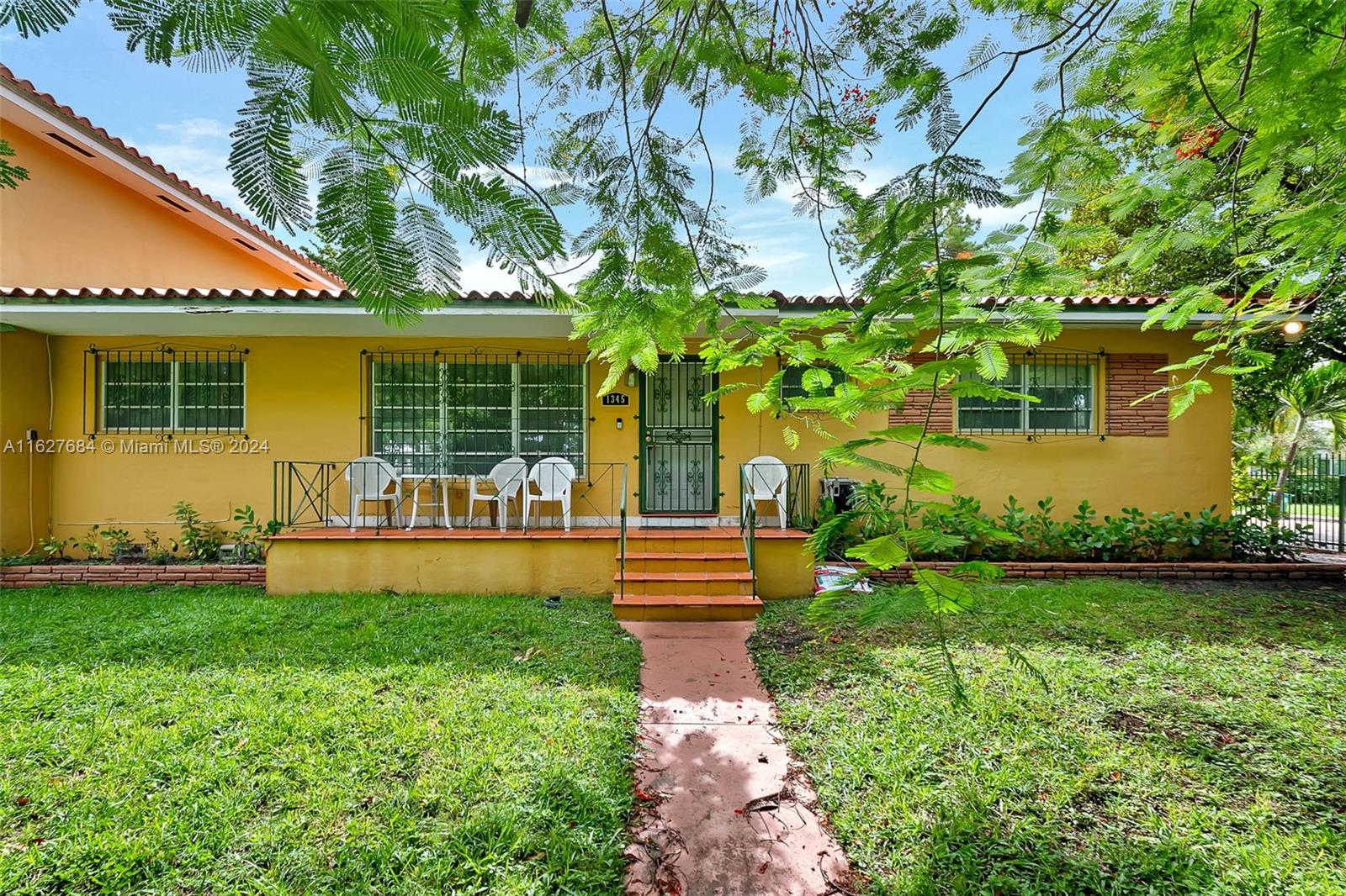 a front view of a house with garden