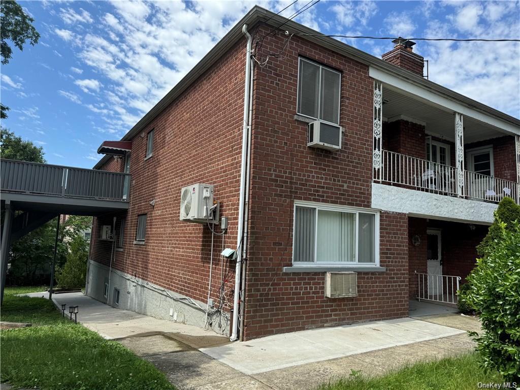 View of home's exterior featuring a balcony and ac unit