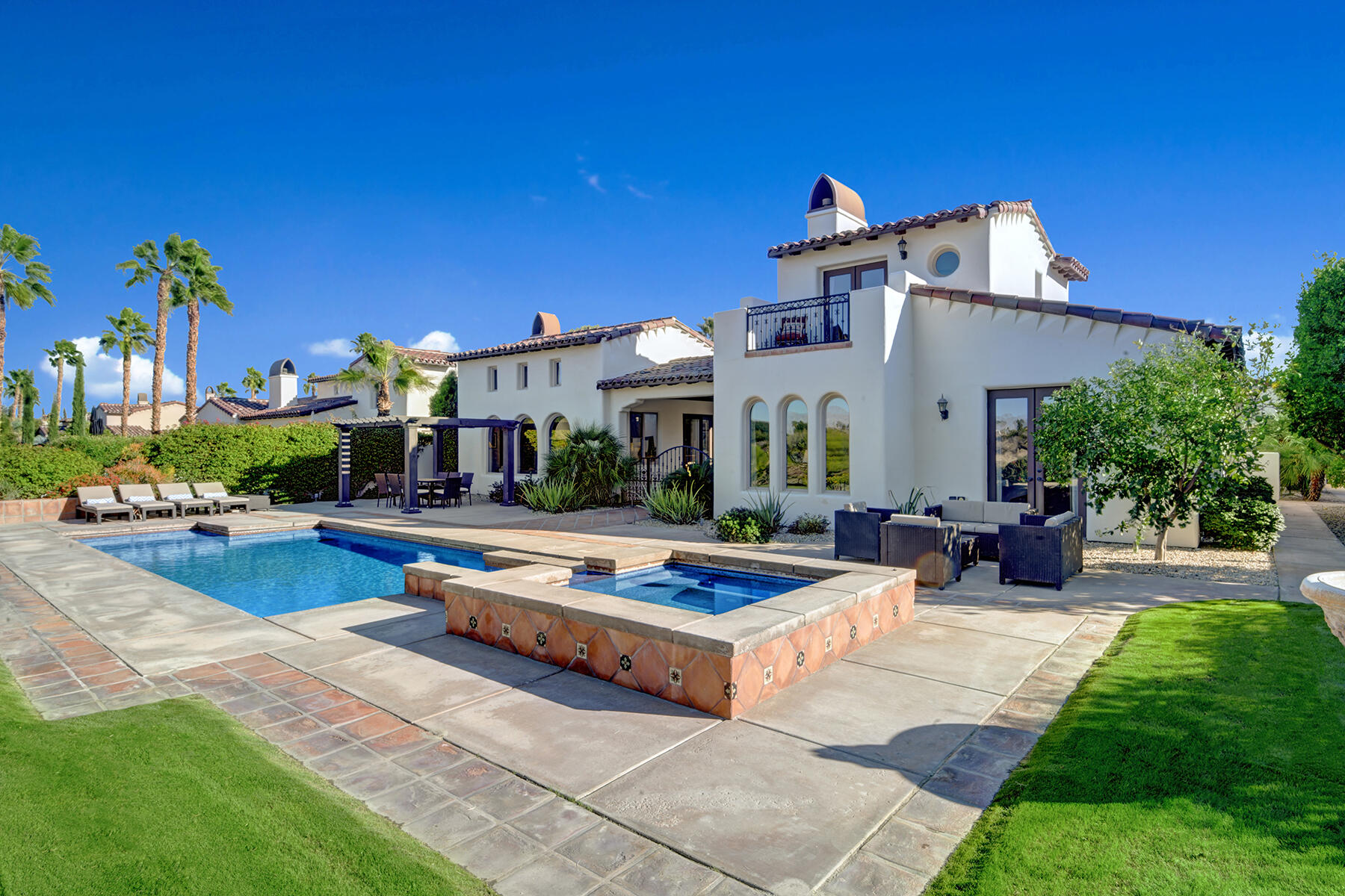 a view of a house with swimming pool and sitting area