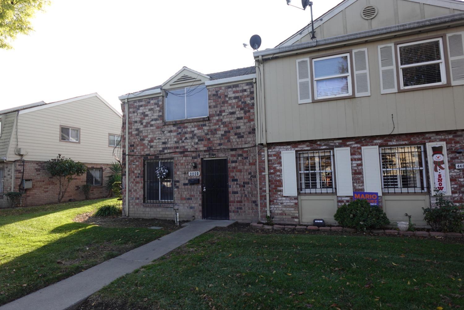 a front view of a house with a yard and porch