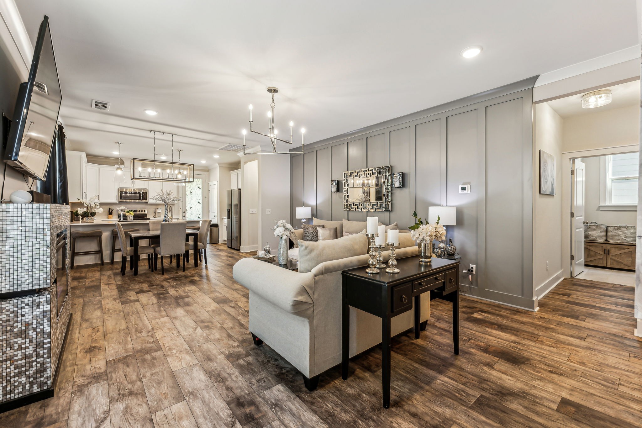 The living room features a stylish baton board accent wall, an upgraded modern light fixture, and recessed lighting. 3730 Felipe Way  Murfreesboro, TN 37129