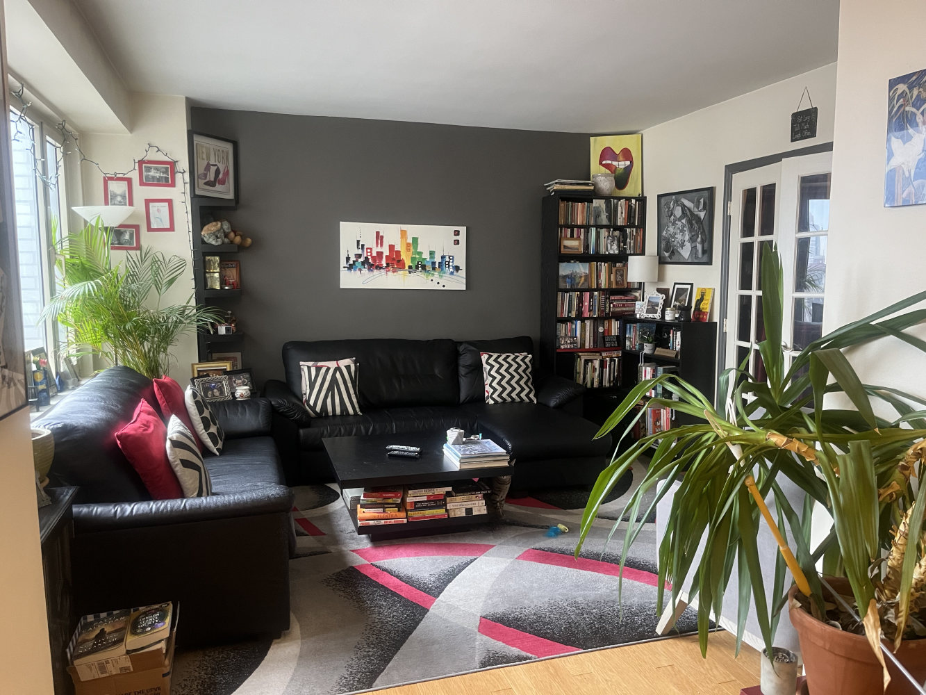 a living room with furniture and a potted plant