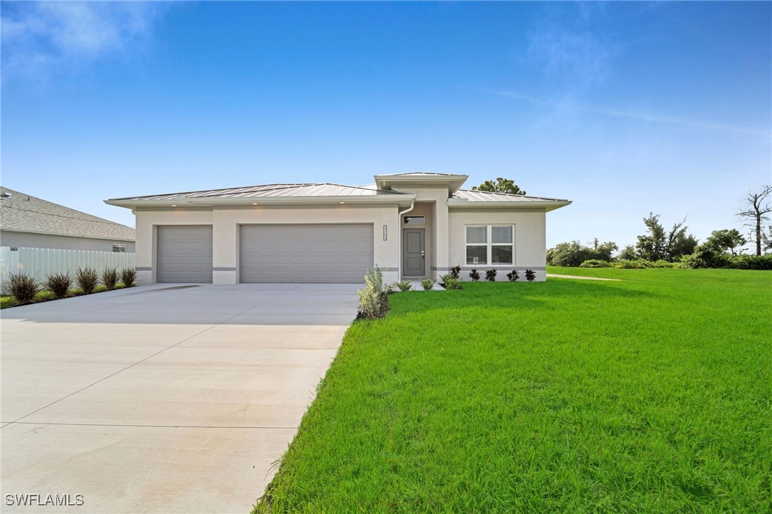 a front view of a house with a yard and garage