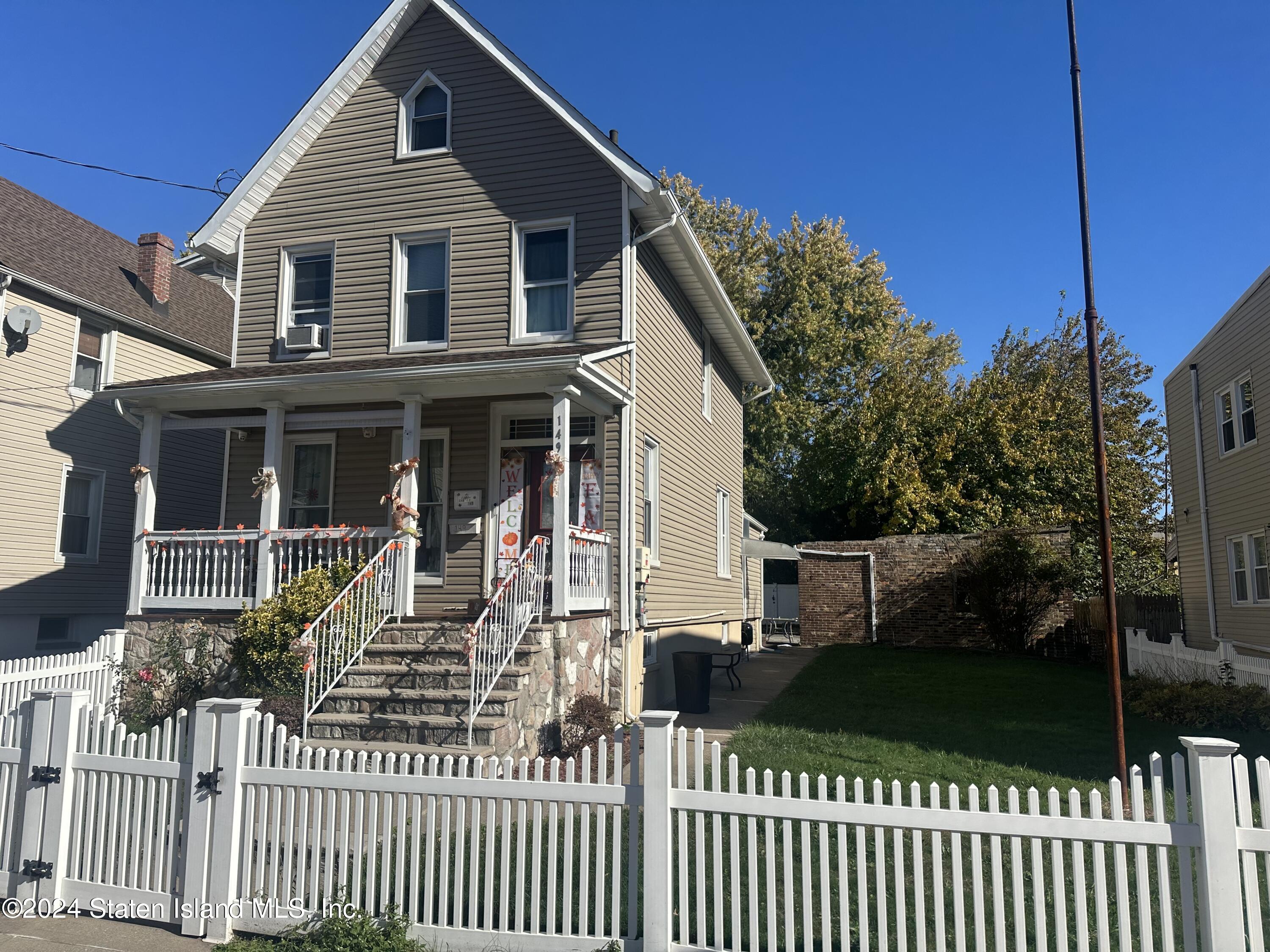 a front view of a house with a fence