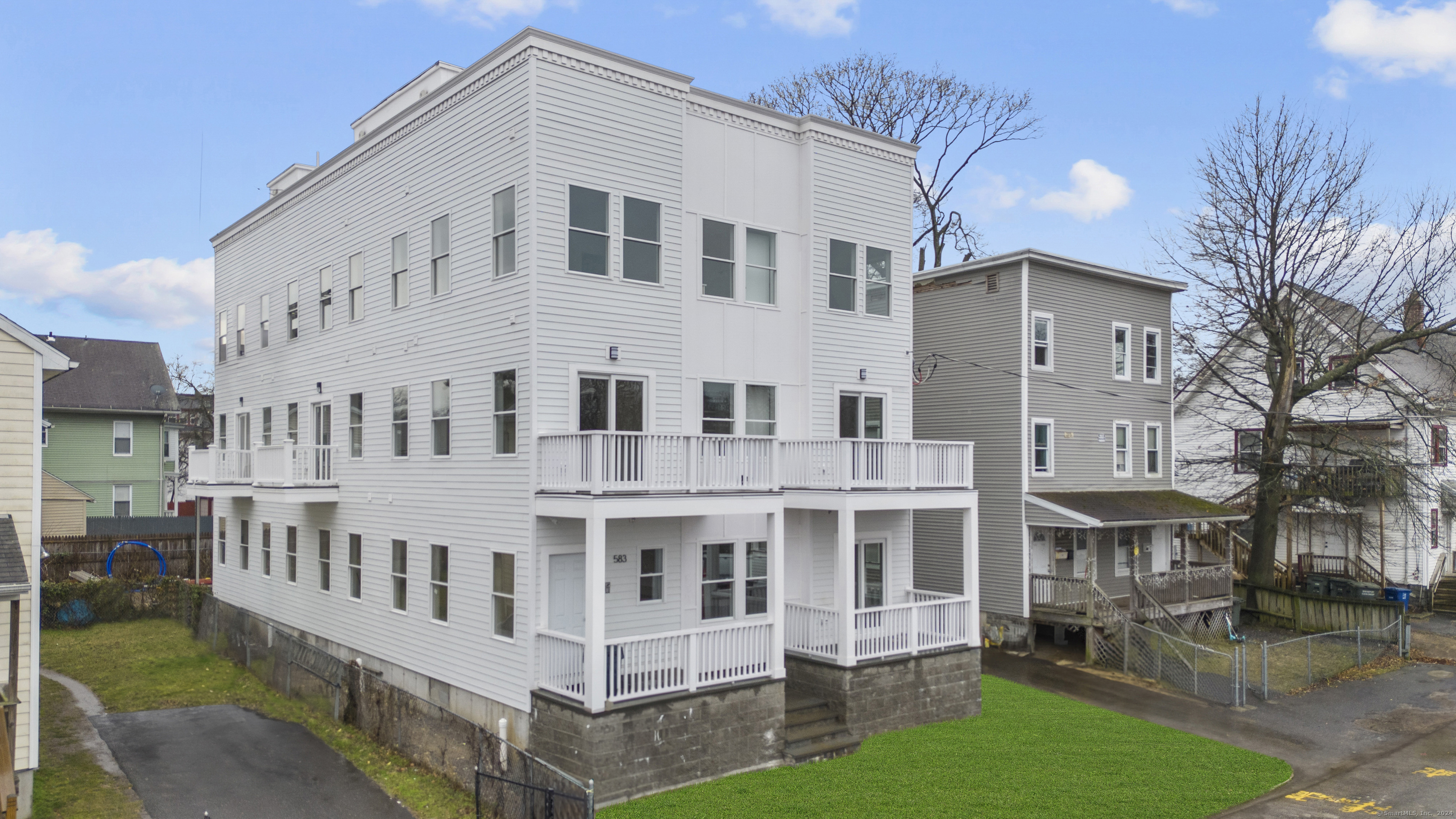 a large white building with a yard in front of it