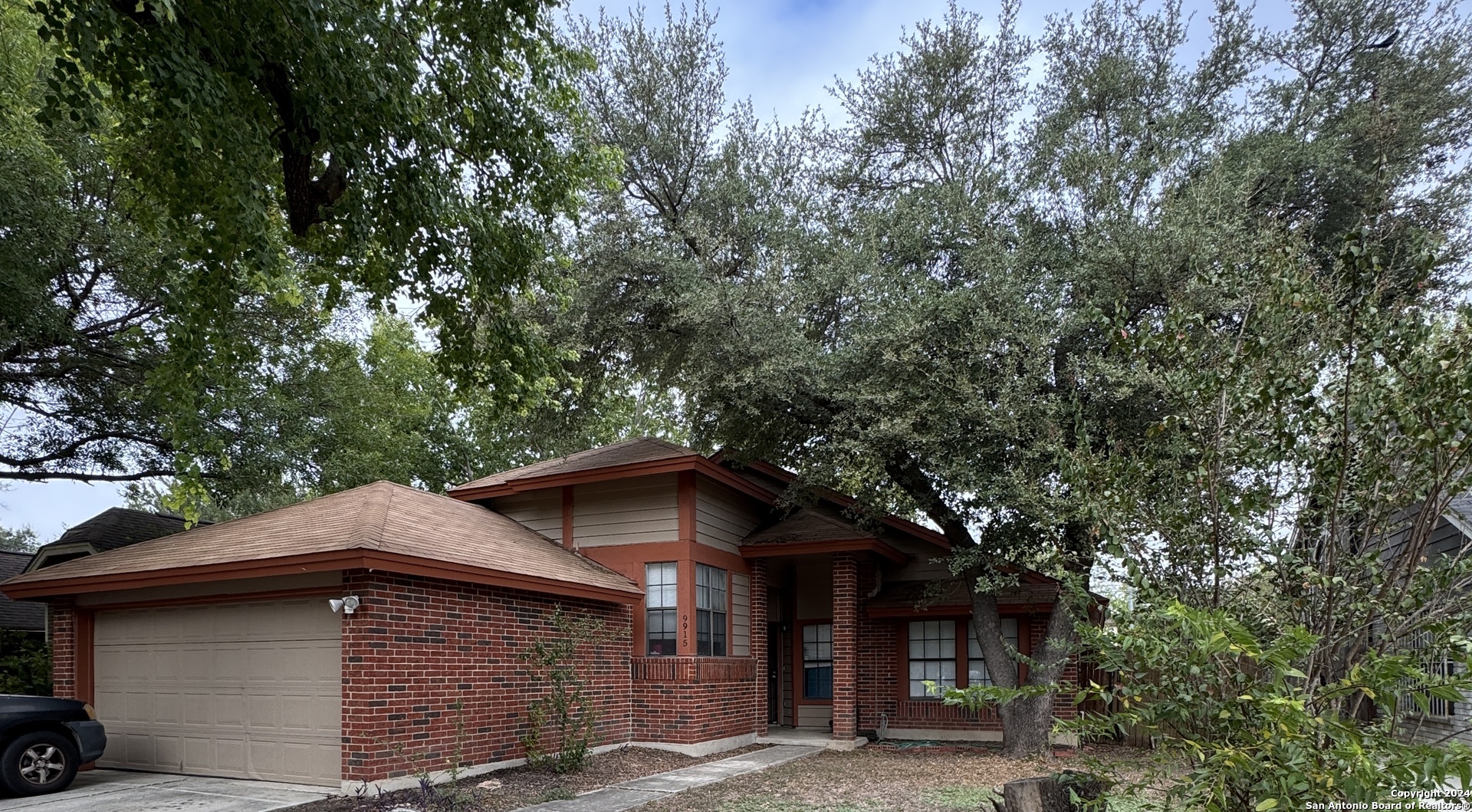 a view of a house with a tree