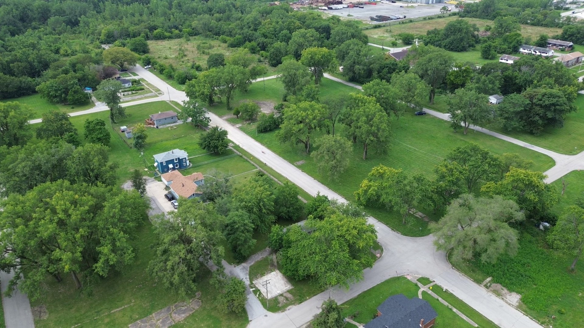 a aerial view of a house with a yard and lake view