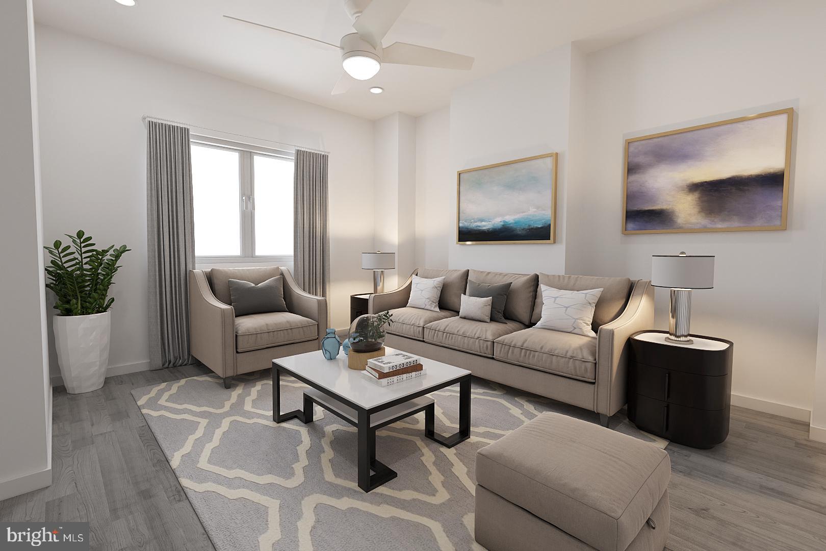 a living room with furniture and a potted plant