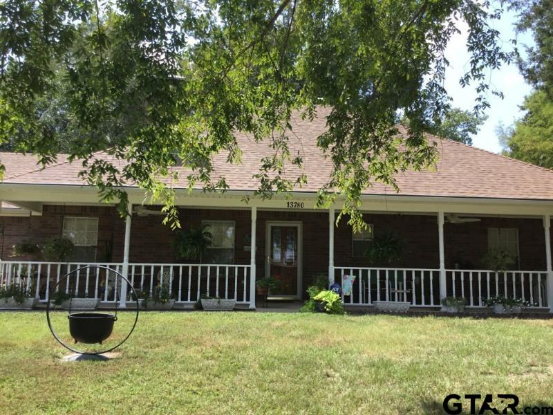 a view of a house with backyard and porch