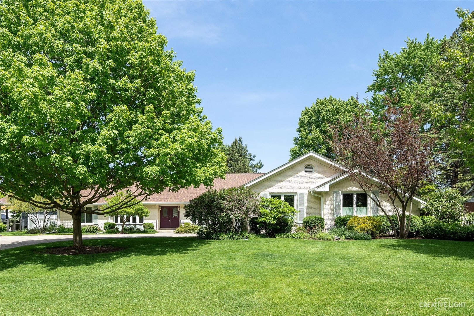 a front view of a house with a garden