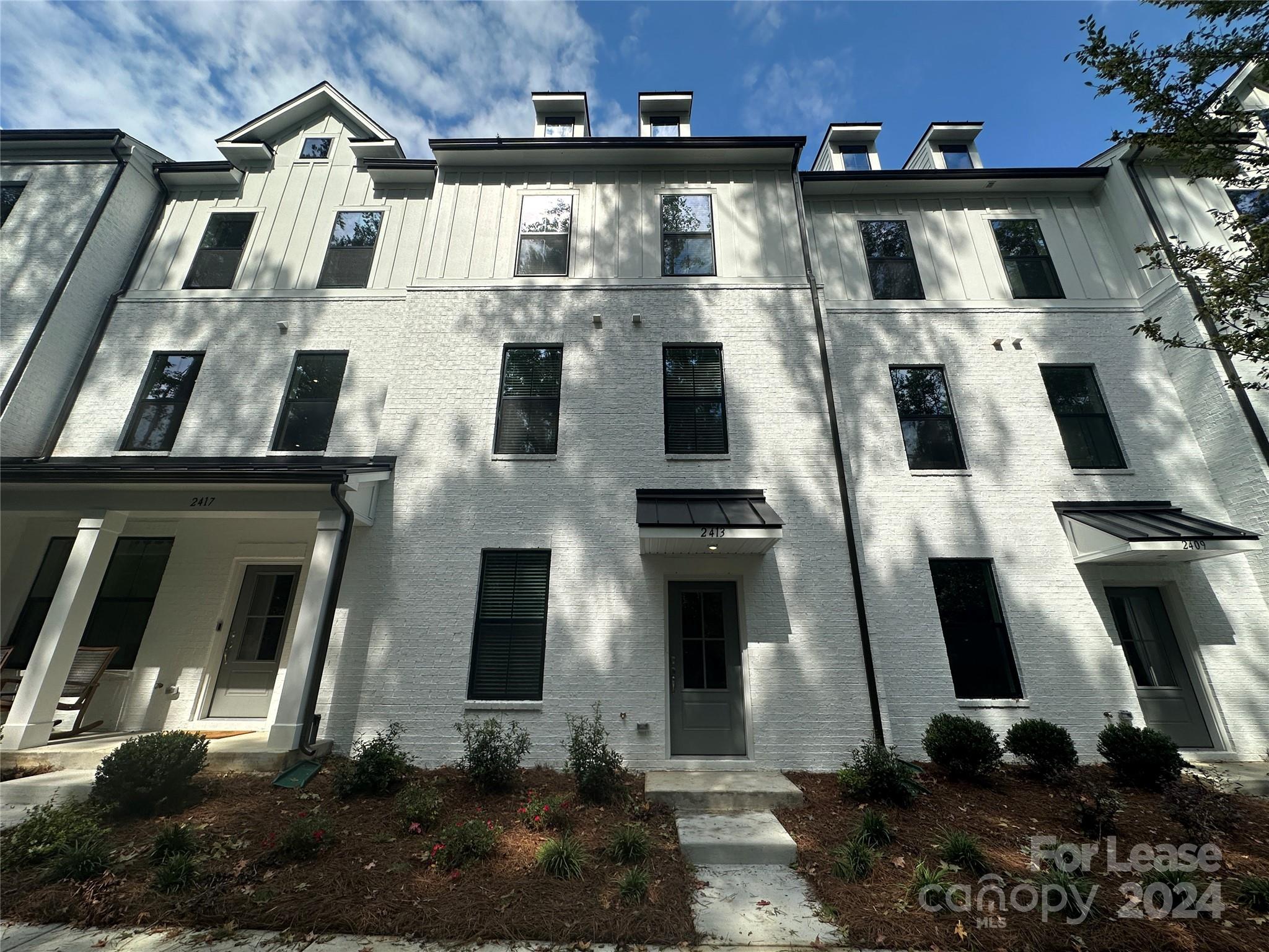 a view of a white building with many windows