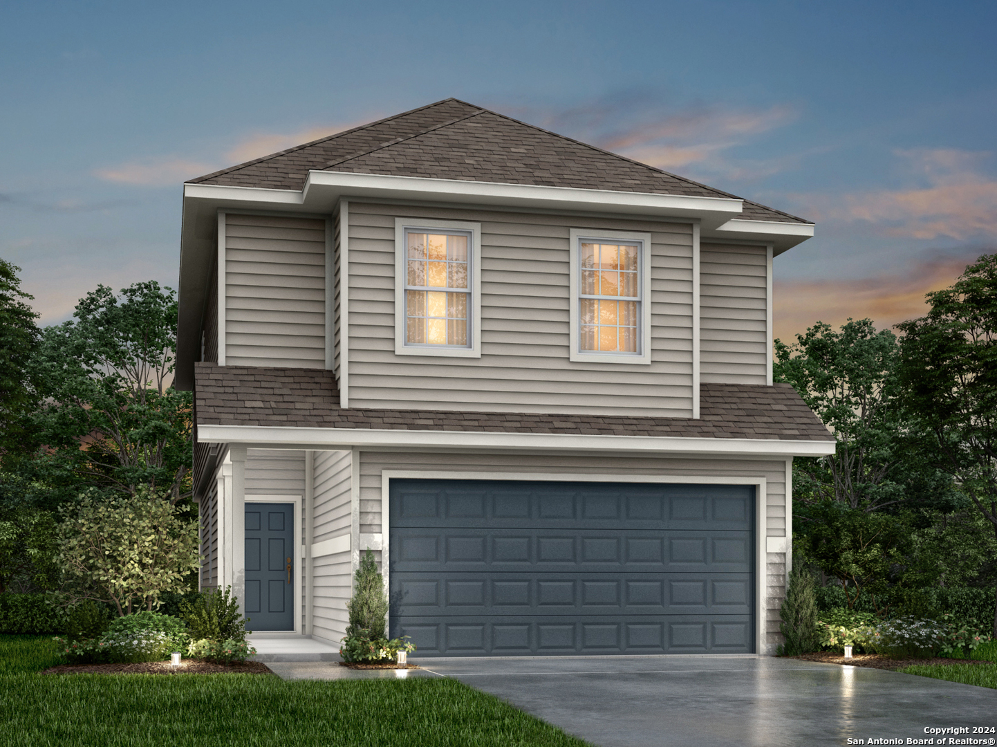 a front view of a house with a yard and garage