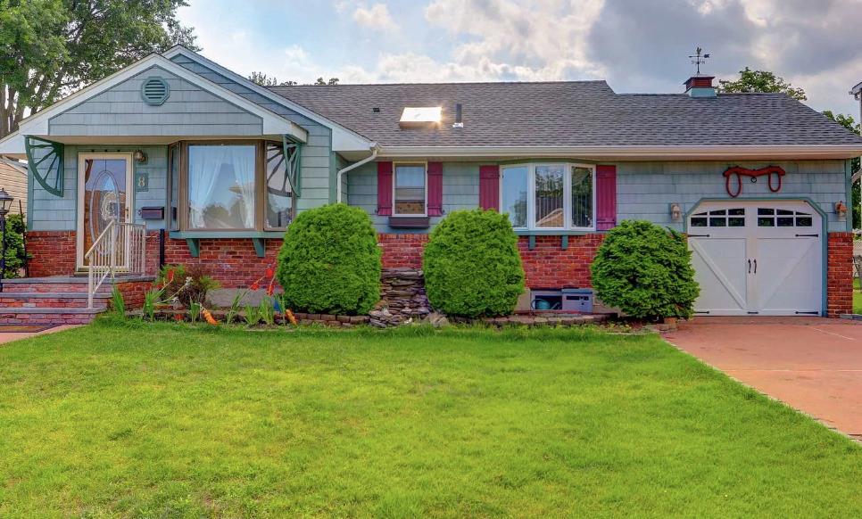 a front view of a house with a garden