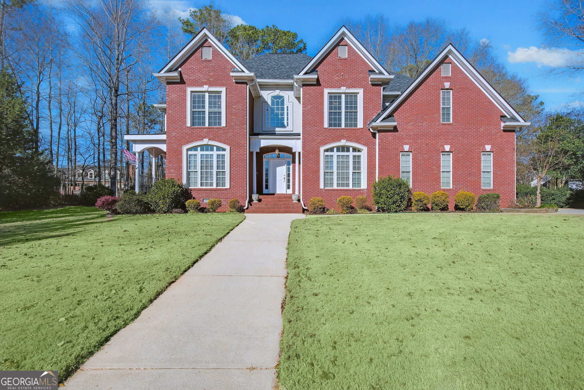 a front view of a house with a yard