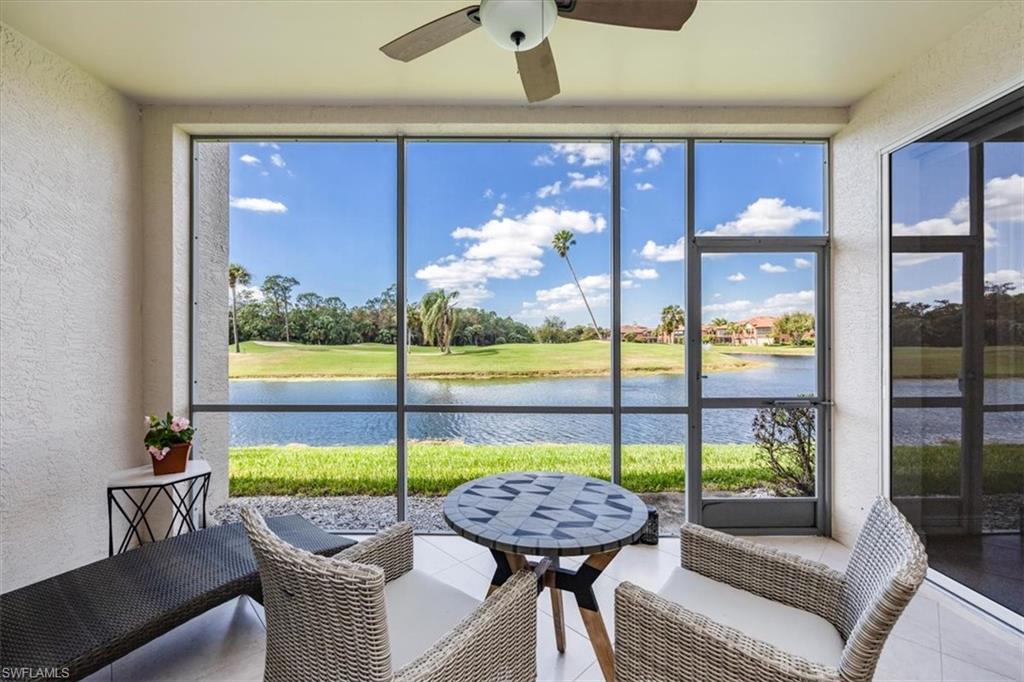 a balcony with furniture and a floor to ceiling window