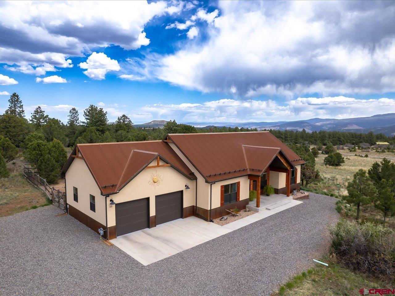 a aerial view of a house with yard and mountain view in back