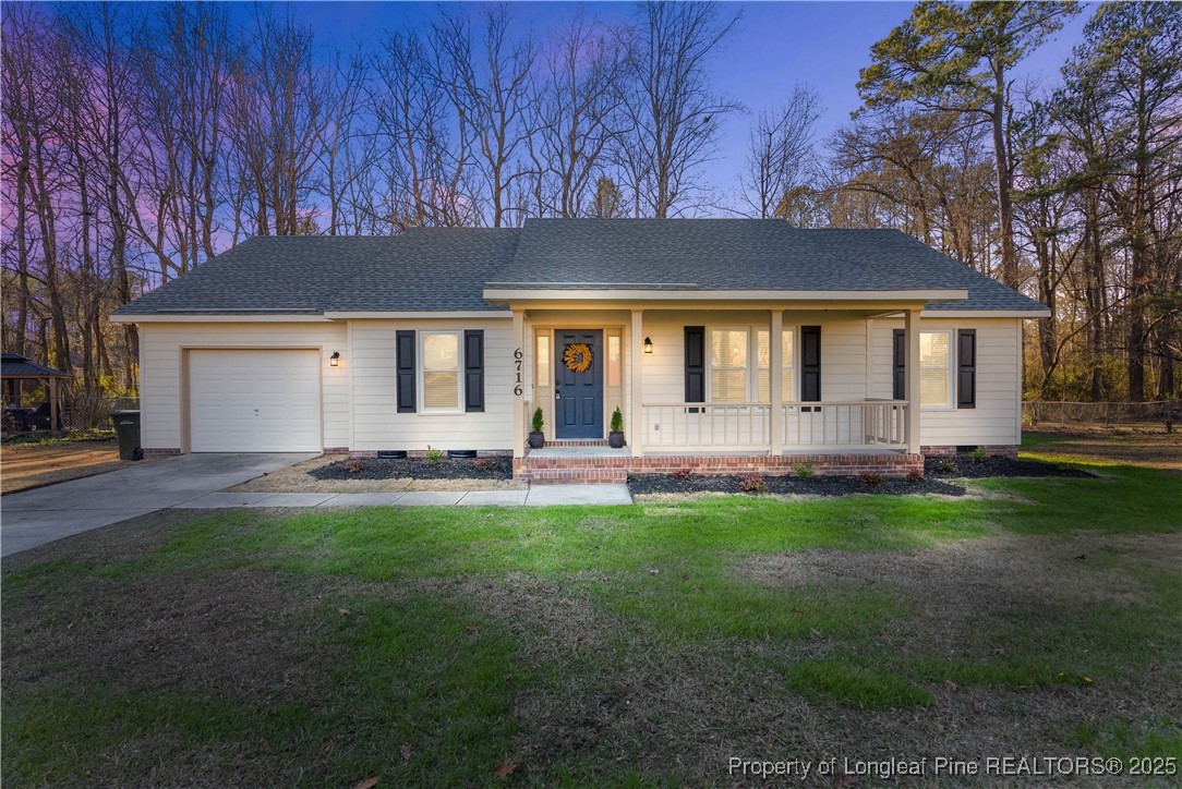 a front view of house with yard barbeque and outdoor seating