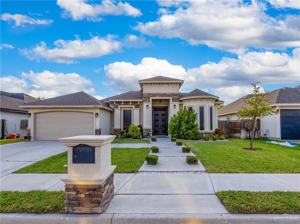 a front view of a house with a yard and garage