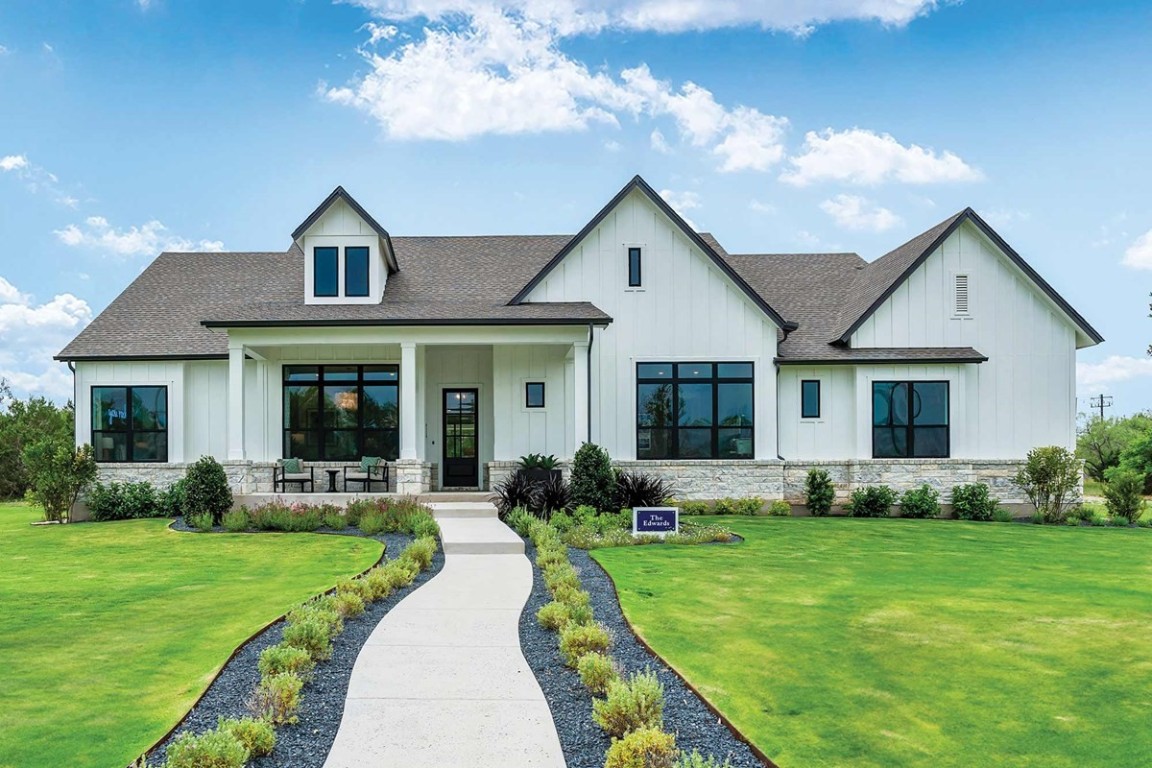 a front view of house with yard and green space