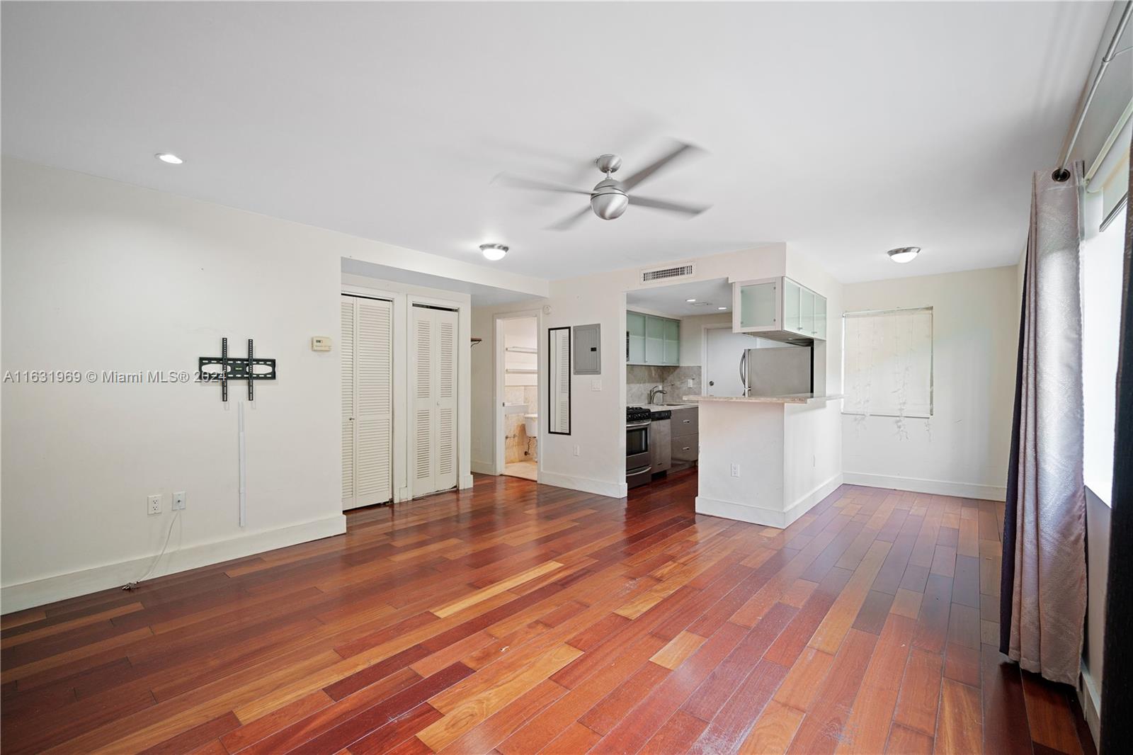 a view of a kitchen with wooden floor and a kitchen