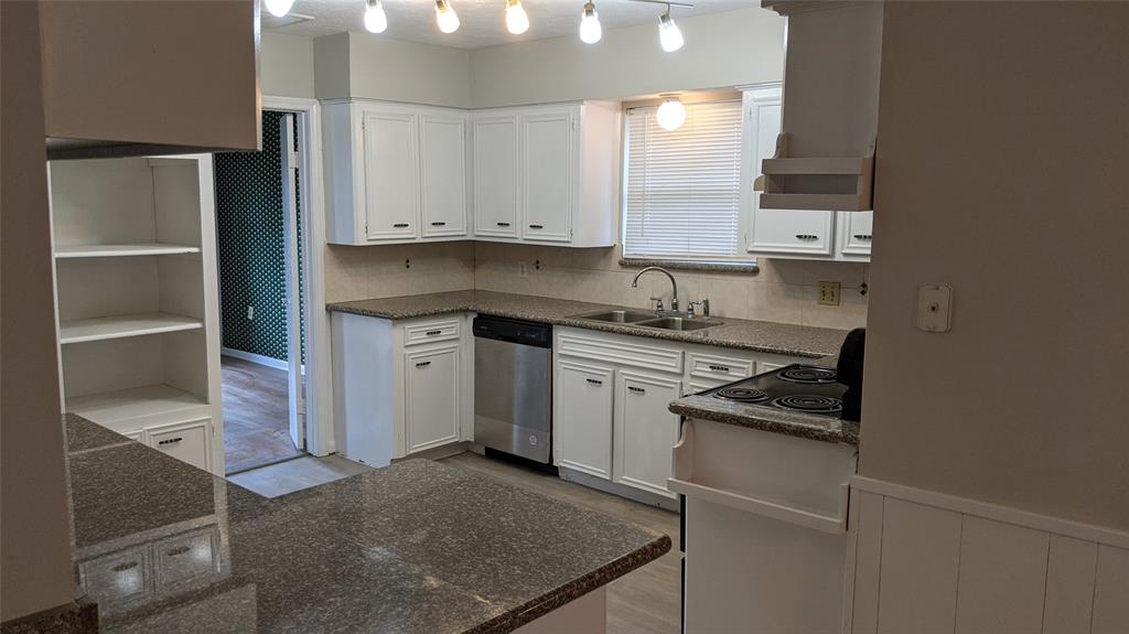 a kitchen with a stove and a refrigerator