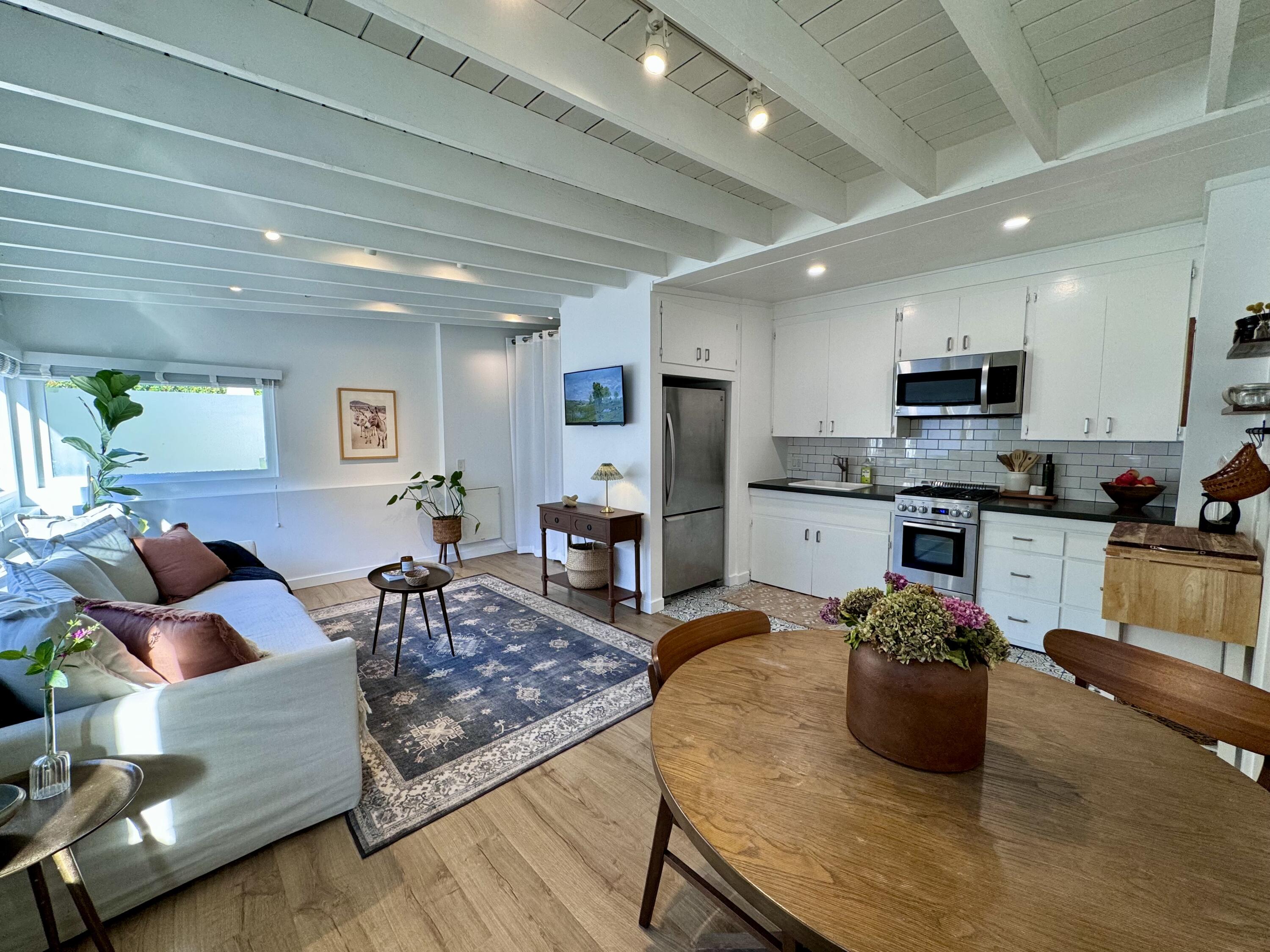 a living room with stainless steel appliances kitchen island granite countertop furniture and a kitchen view