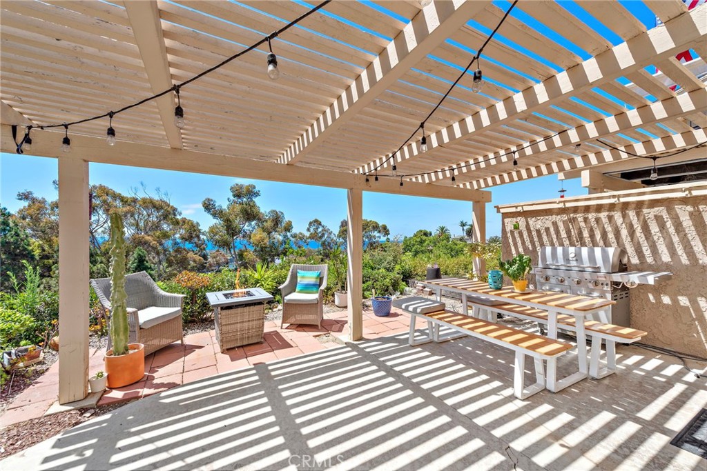 a view of a patio with table and chairs potted plants with wooden floor