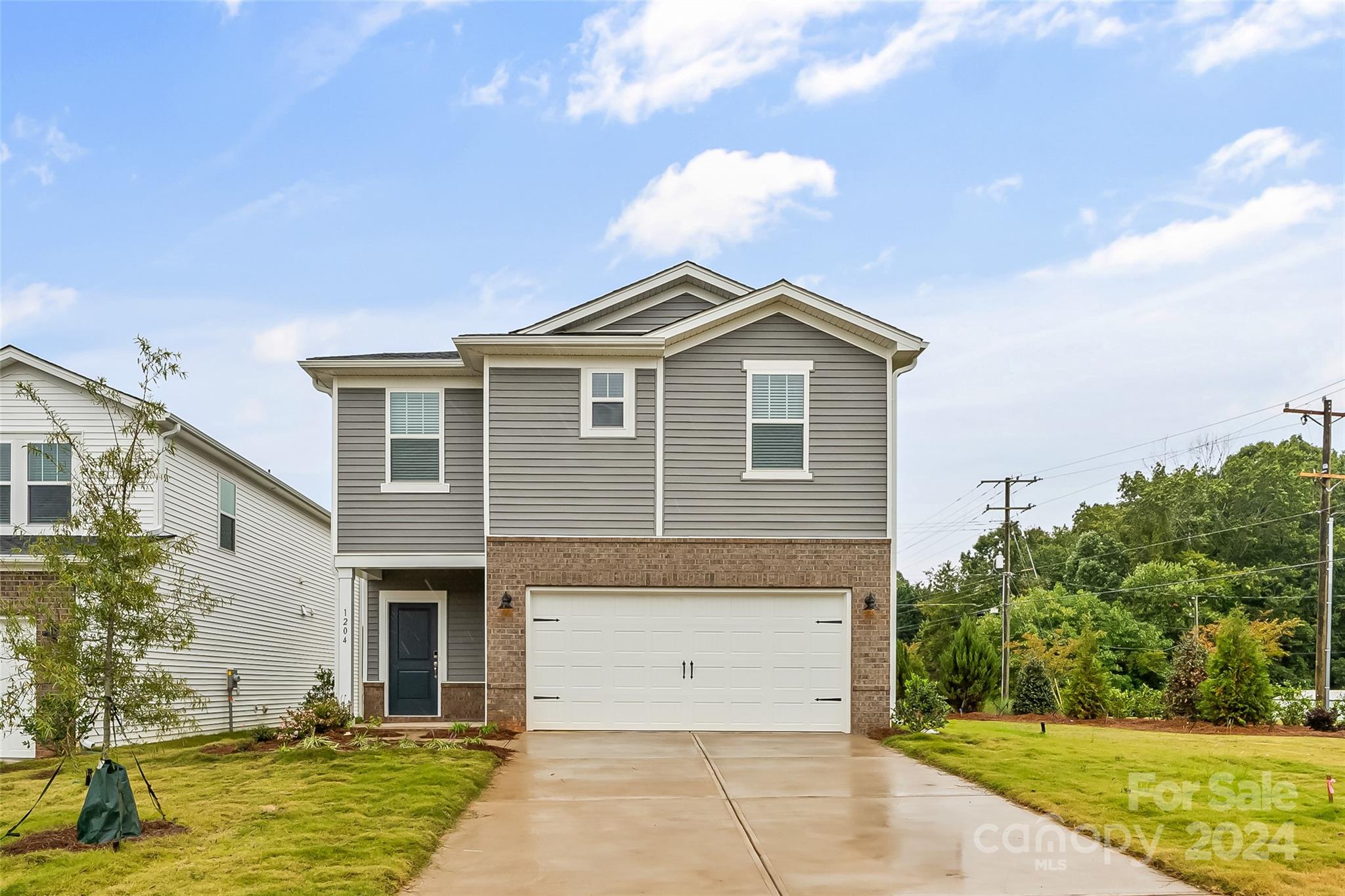 a front view of a house with a yard garage and outdoor seating