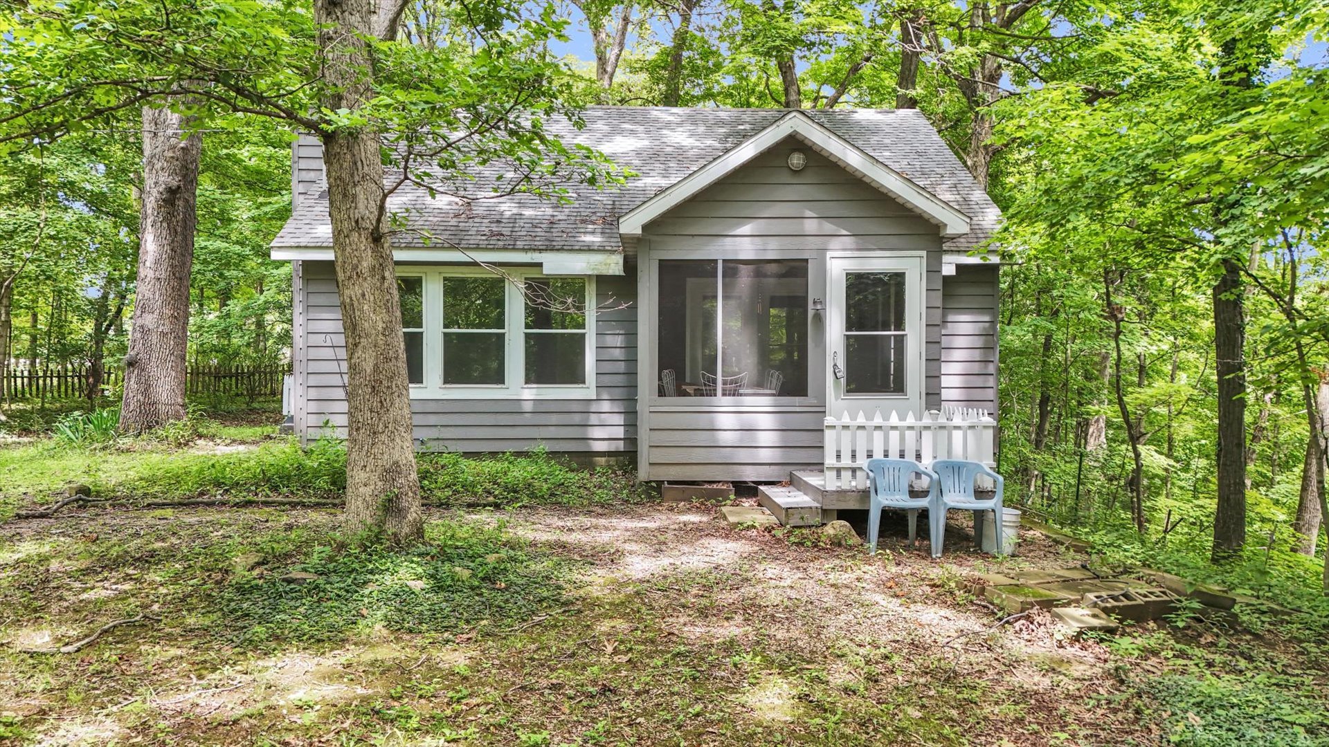 a view of a house with a yard and large tree