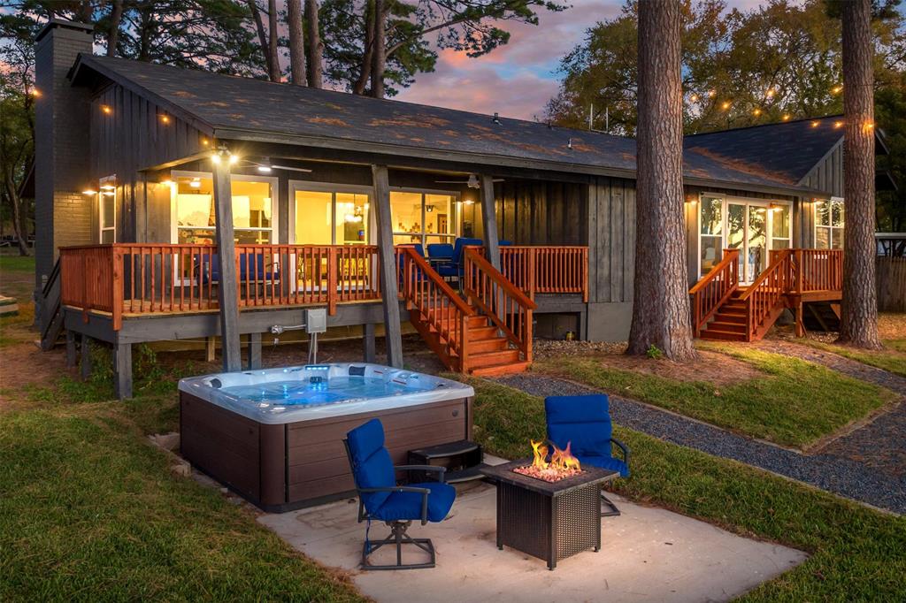 a backyard of a house with fountain table and chairs