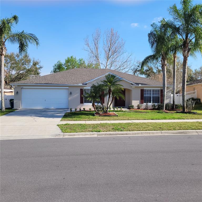 a view of house with outdoor space and palm trees