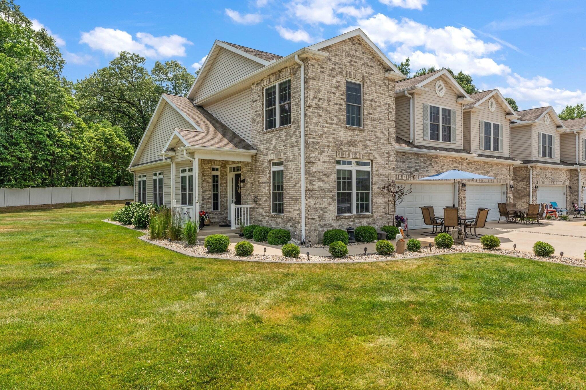 a front view of house with yard and green space