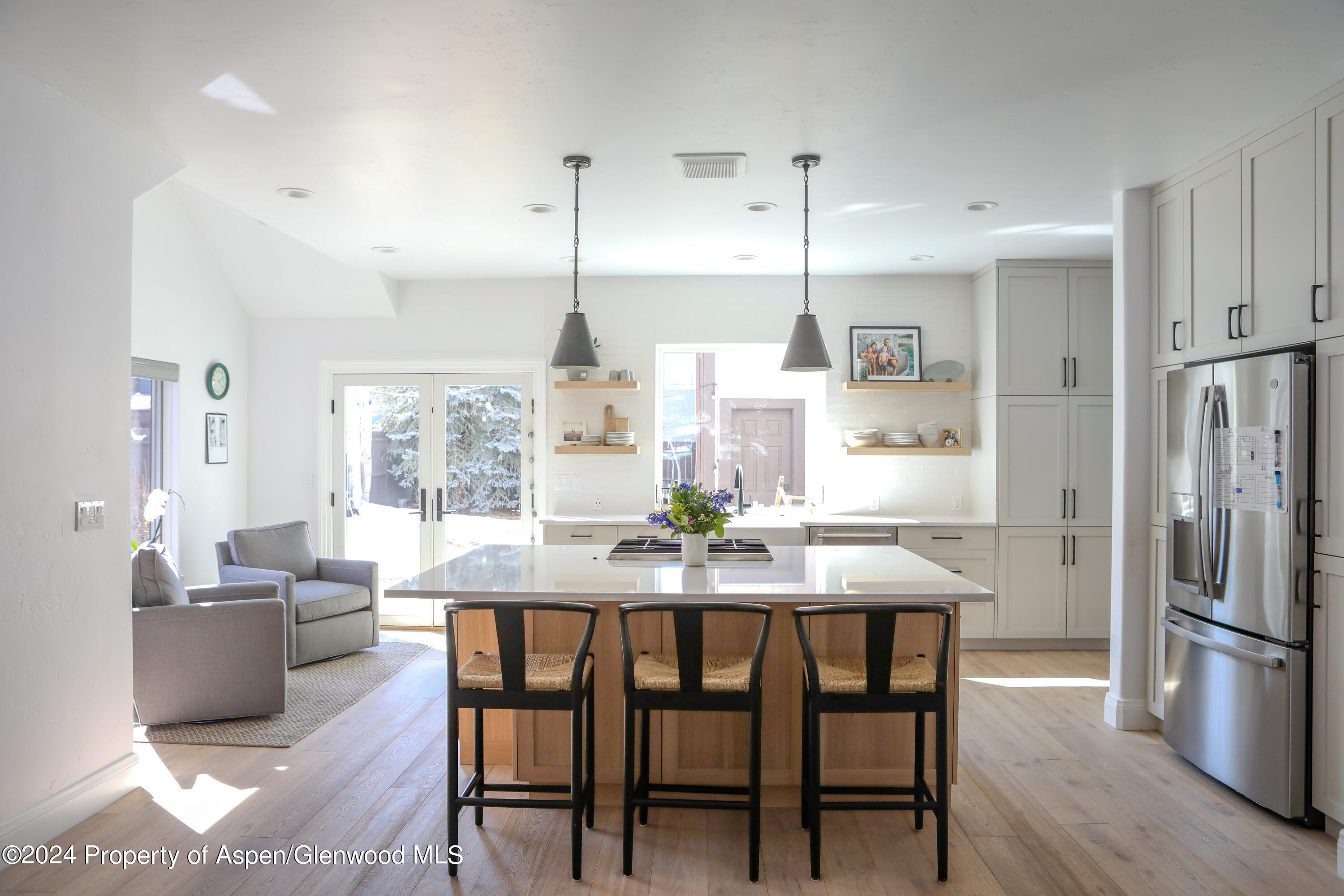 a dining room with furniture a chandelier and wooden floor