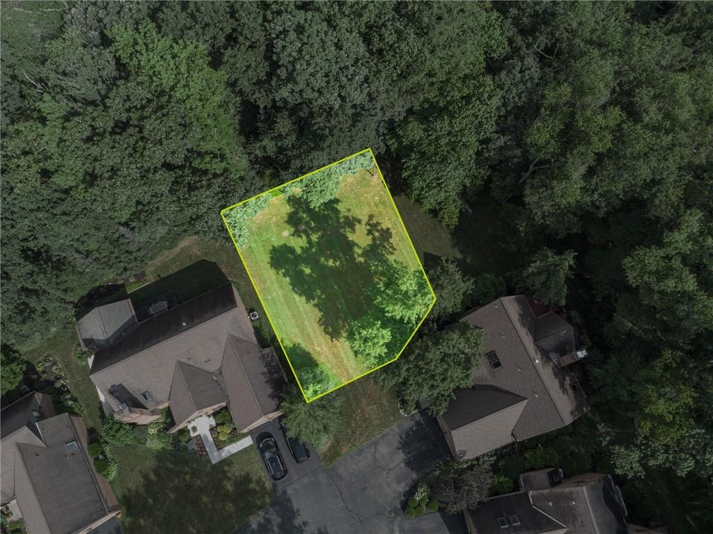 an aerial view of a residential house with a yard and outdoor seating