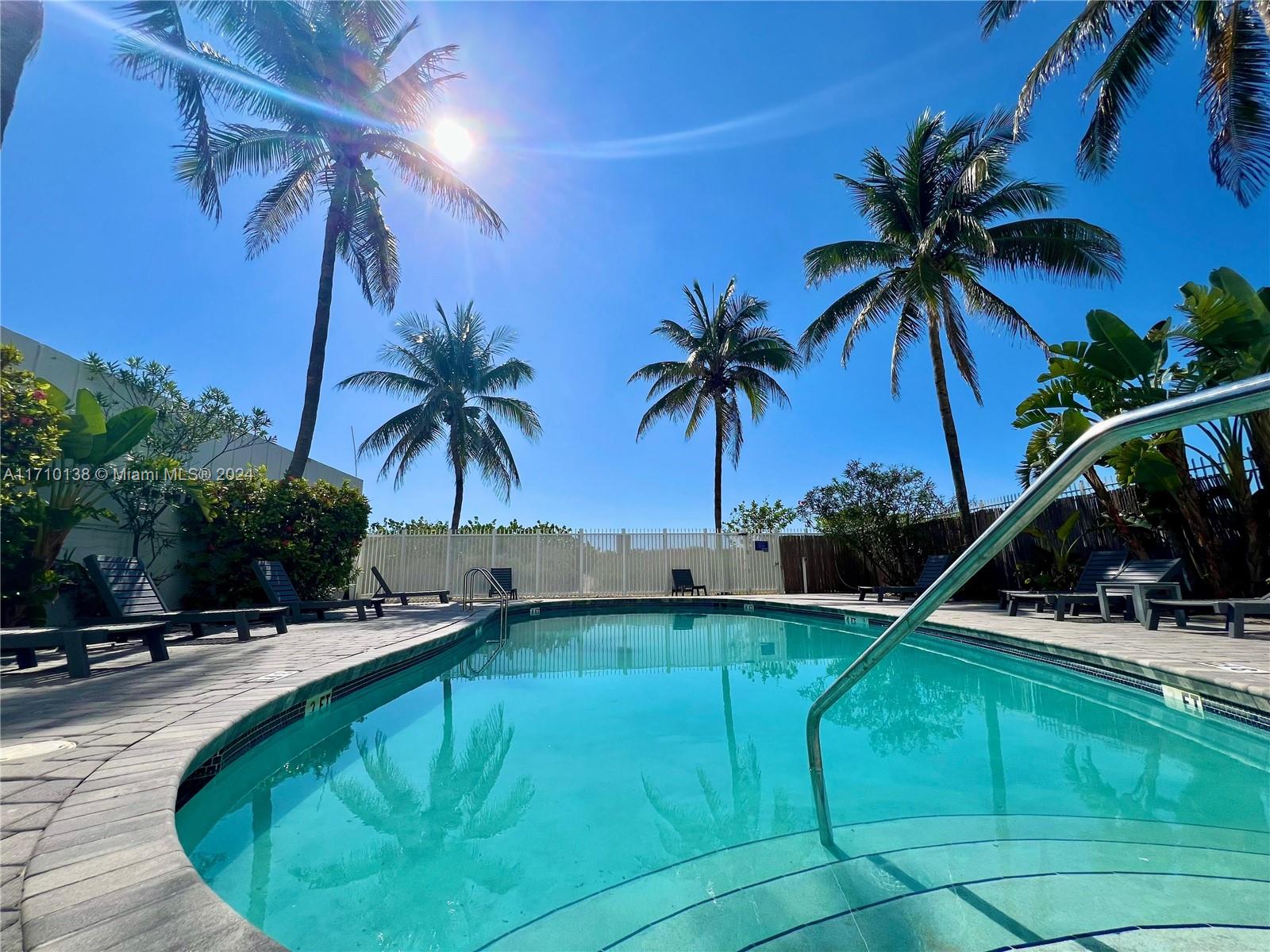 a swimming pool with outdoor seating and yard