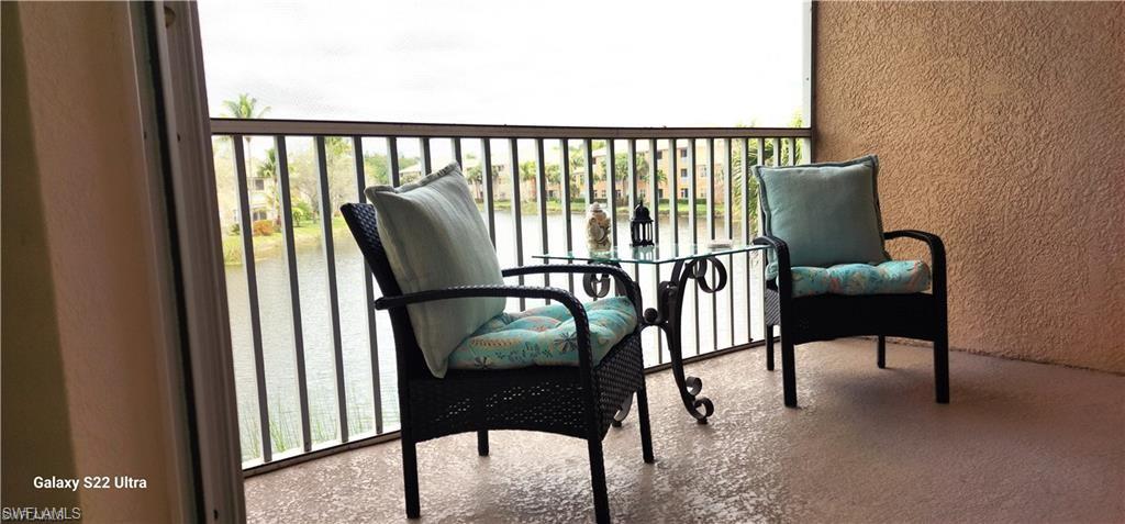 a view of a chairs and table in the balcony