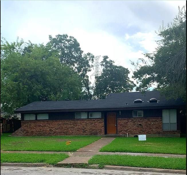 a front view of a house with a garden and plants