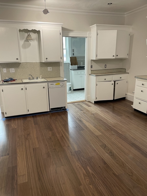 a view of a kitchen with electric appliances and cabinets