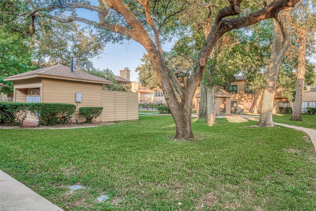 a view of a house with yard and tree s