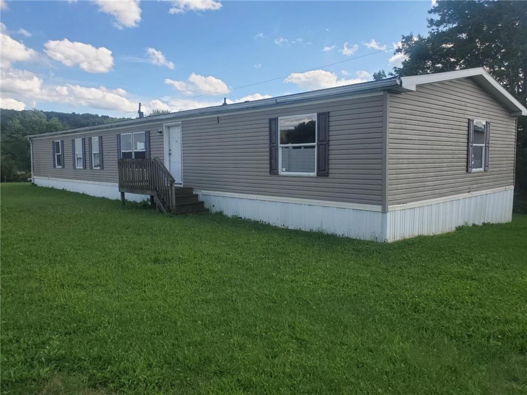 a view of a house with a backyard