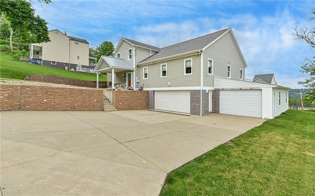 a view of a house with a yard and garage