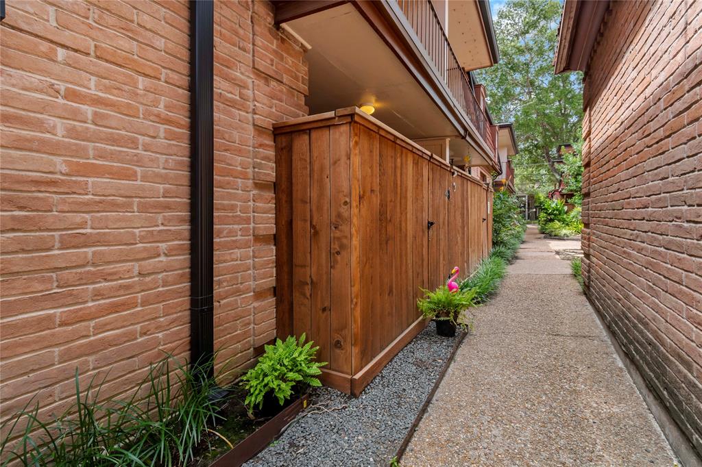 a backyard with potted plants and wooden fence