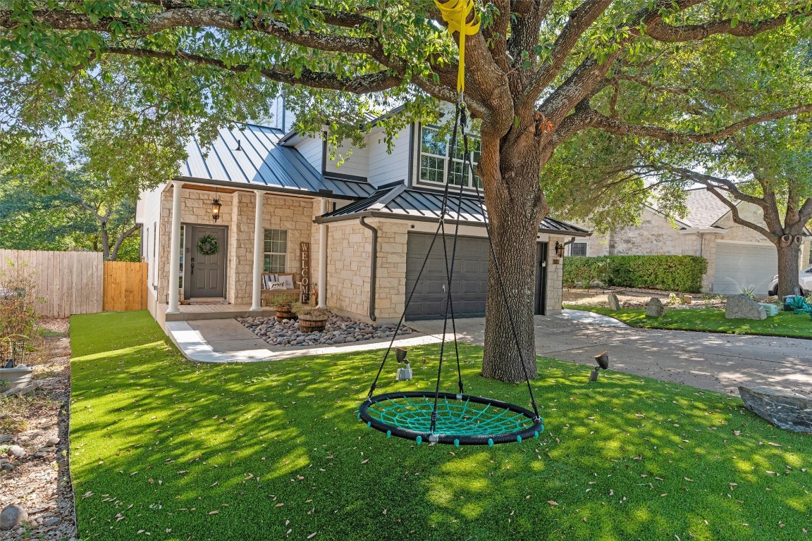 a view of a house with backyard and sitting area